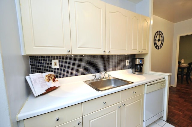 kitchen featuring dishwasher, a sink, tasteful backsplash, and light countertops