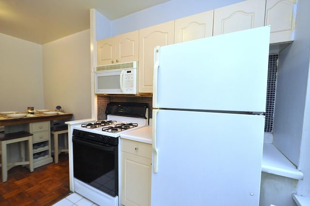 kitchen with white appliances, white cabinets, and light countertops