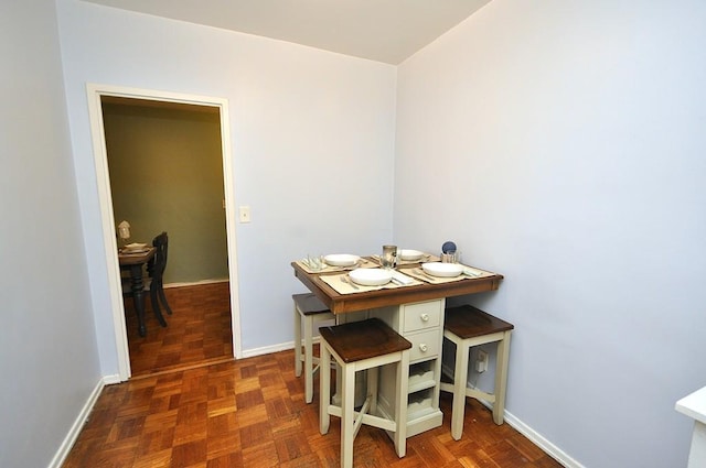 dining space featuring baseboards
