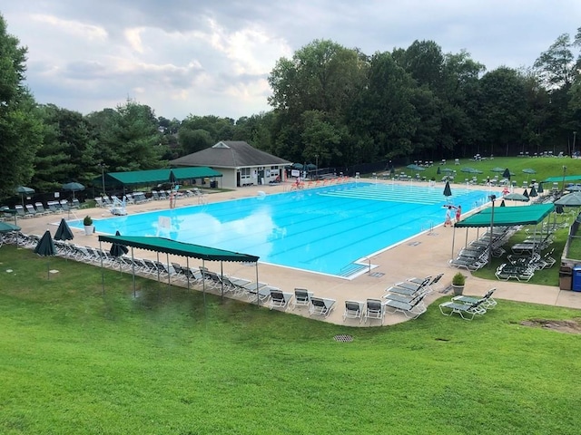 community pool featuring a lawn