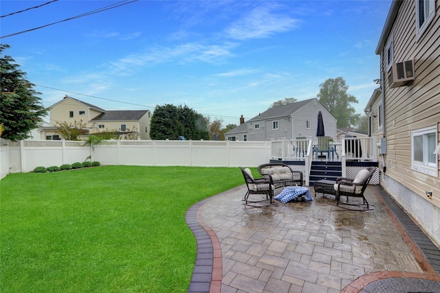 view of yard with an outdoor hangout area, a patio area, a wooden deck, and a fenced backyard
