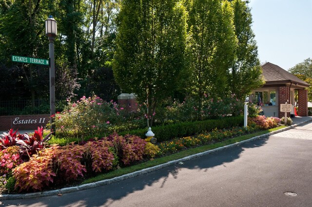 exterior space featuring curbs and street lighting
