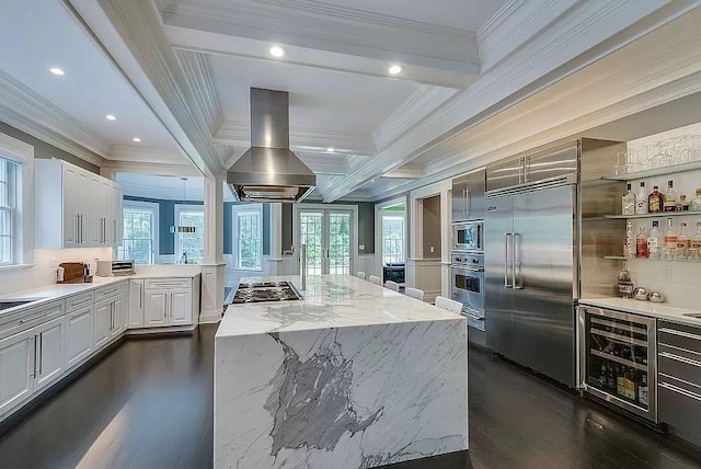 2 Short Path, Nissequogue, NY 11780 - kitchen with island range hood, crown molding, dark wood finished floors, built in appliances, and wine cooler
