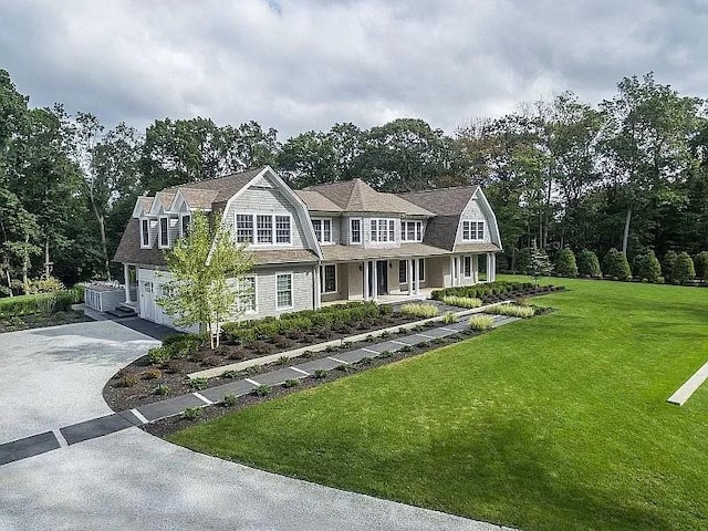 2 Short Path, Nissequogue, NY 11780 - shingle-style home featuring covered porch, an attached garage, a gambrel roof, driveway, and a front yard
