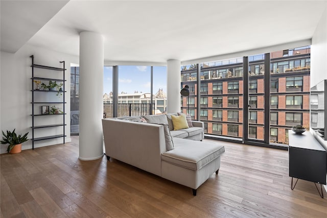 living area featuring floor to ceiling windows and wood finished floors