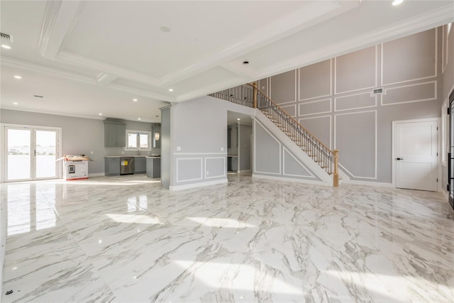 unfurnished living room with visible vents, a decorative wall, ornamental molding, and stairway