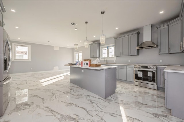 kitchen with gray cabinetry, visible vents, appliances with stainless steel finishes, and wall chimney exhaust hood
