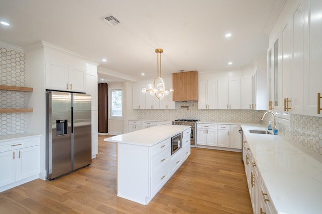 396 Argyle Rd, East Meadow, NY 11554 - kitchen featuring stainless steel appliances, a sink, light countertops, a chandelier, and recessed lighting