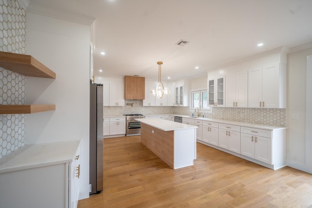 396 Argyle Rd, East Meadow, NY 11554 - kitchen with stainless steel appliances, open shelves, decorative backsplash, light wood finished floors, and light countertops