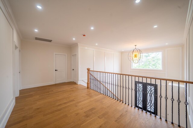 396 Argyle Rd, East Meadow, NY 11554 - hall featuring wood finished floors, crown molding, a chandelier, baseboards, and recessed lighting