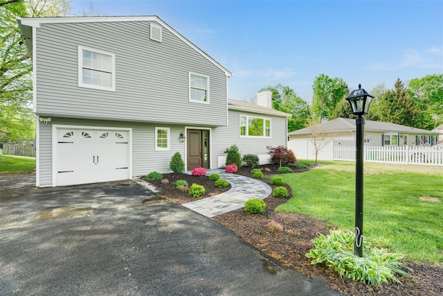 5 Helen Dr, Wappingers Falls, NY 12590 - tri-level home featuring an attached garage, a chimney, and driveway