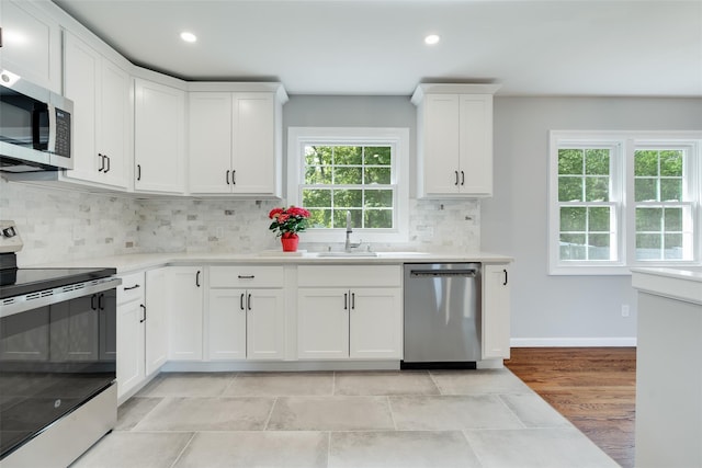 5 Helen Dr, Wappingers Falls, NY 12590 - kitchen with appliances with stainless steel finishes, a sink, light countertops, recessed lighting, and white cabinets