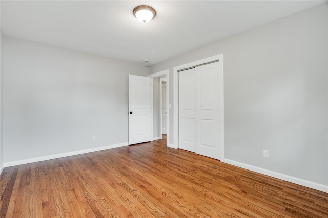 5 Helen Dr, Wappingers Falls, NY 12590 - unfurnished bedroom featuring baseboards, wood finished floors, and a closet