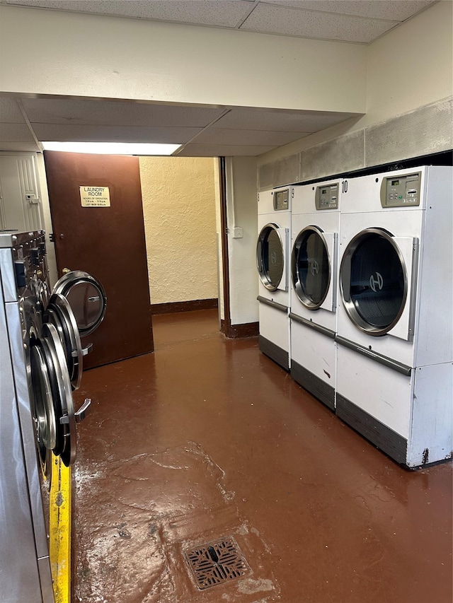 shared laundry with washing machine and dryer and baseboards