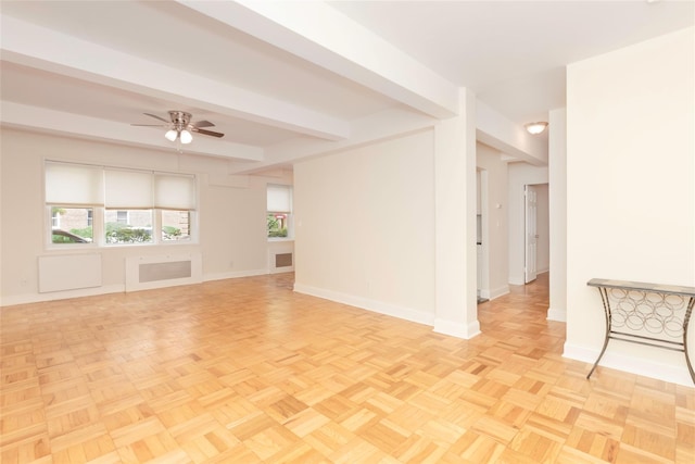 unfurnished room with baseboards, ceiling fan, and beam ceiling