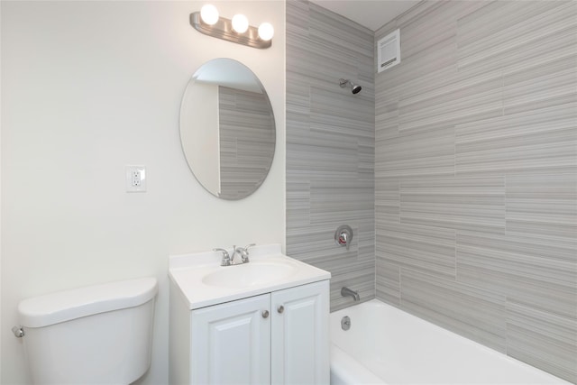 bathroom featuring toilet, vanity, and bathing tub / shower combination