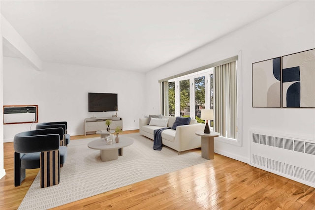 146-24 27th Ave, Flushing, NY 11354 - living area featuring radiator, wood finished floors, and baseboards