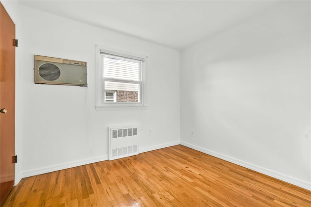 146-24 27th Ave, Flushing, NY 11354 - empty room with radiator heating unit, light wood-style floors, and baseboards