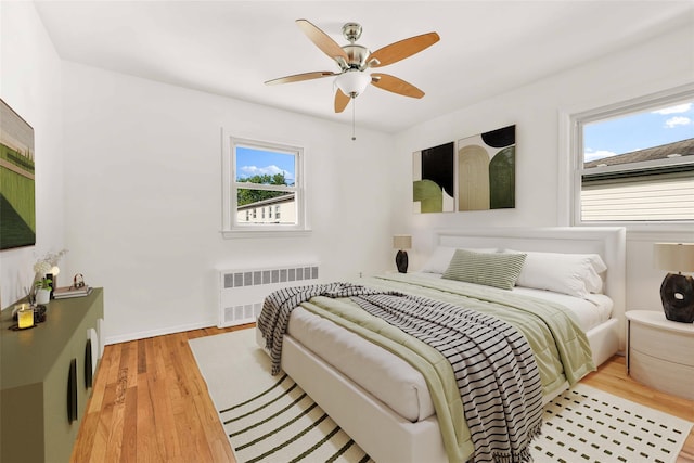146-24 27th Ave, Flushing, NY 11354 - bedroom with radiator heating unit, light wood-style flooring, baseboards, and a ceiling fan