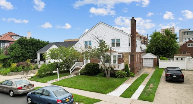 56 W Beech St, Long Beach, NY 11561 - view of front of house with concrete driveway, a garage, brick siding, and a front yard