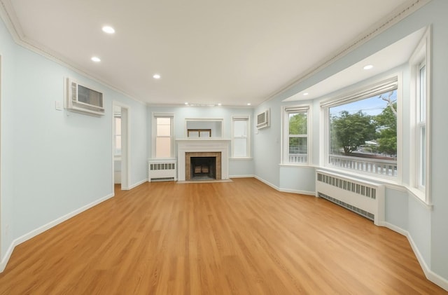 56 W Beech St, Long Beach, NY 11561 - unfurnished living room with light wood-type flooring, radiator, and a wall unit AC