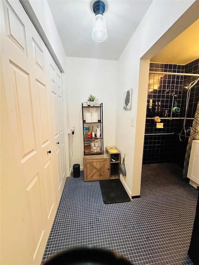 hall with baseboards and dark carpet