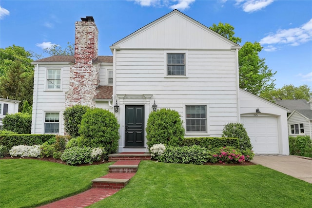 35 Brooke Ave, Bronxville, NY 10708 - view of front facade featuring concrete driveway, a chimney, a front lawn, and an attached garage