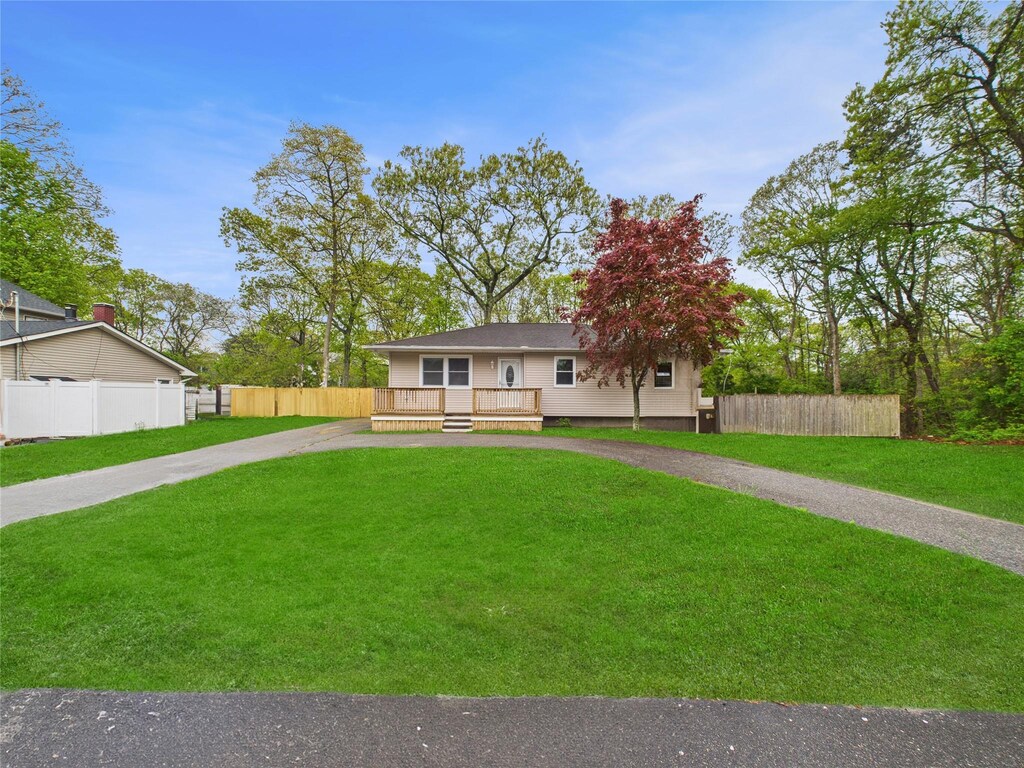 170 Mastic Blvd, Mastic, NY 11950 - view of front facade featuring a front lawn, driveway, a deck, and fence