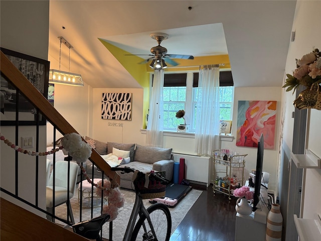 living room with wood finished floors, ceiling fan, stairs, and baseboards
