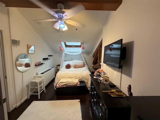 bedroom with a skylight, a ceiling fan, and vaulted ceiling