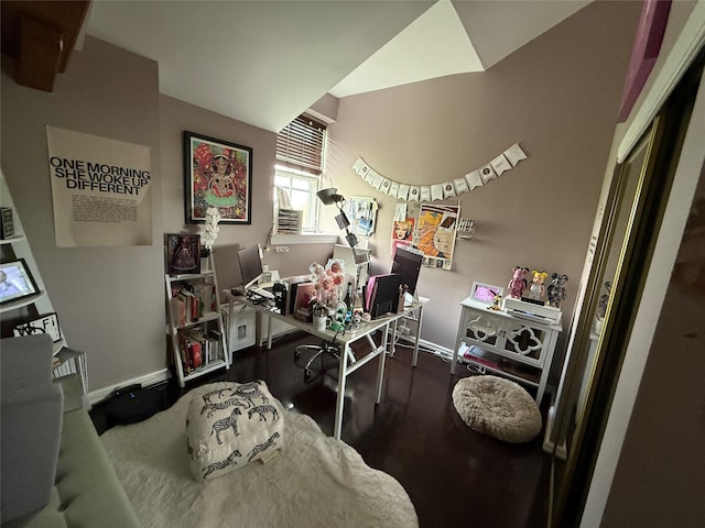 office area with baseboards, wood finished floors, and lofted ceiling