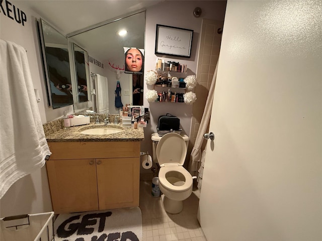 bathroom with vanity, toilet, and tile patterned flooring