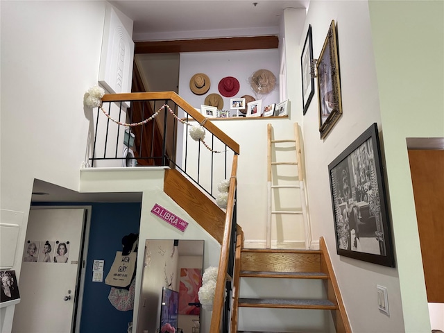 stairs featuring a high ceiling