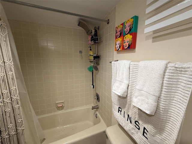 bathroom featuring shower / bath combination with curtain and toilet