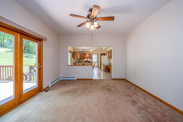 253 W Main St, Stony Point, NY 10980 - unfurnished living room featuring plenty of natural light, a ceiling fan, light colored carpet, and a baseboard radiator