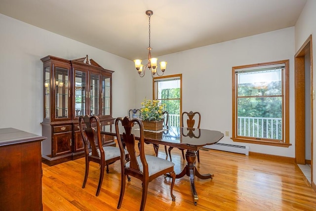 253 W Main St, Stony Point, NY 10980 - dining space with baseboard heating, a chandelier, light wood-type flooring, and baseboards