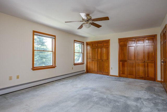 253 W Main St, Stony Point, NY 10980 - unfurnished bedroom featuring a baseboard radiator, two closets, light carpet, ceiling fan, and baseboards