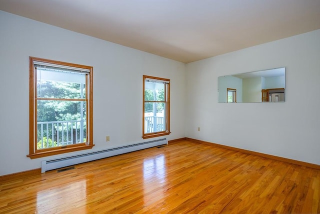 253 W Main St, Stony Point, NY 10980 - empty room with a baseboard heating unit, light wood-style floors, and baseboards