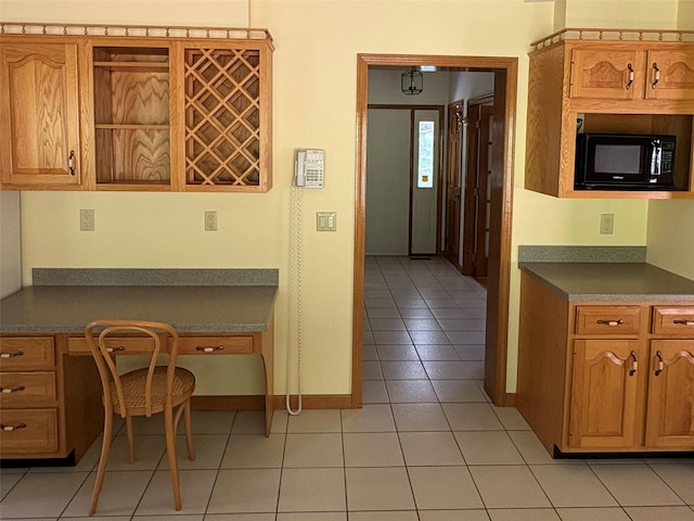 253 W Main St, Stony Point, NY 10980 - kitchen featuring black microwave, dark countertops, light tile patterned floors, and baseboards