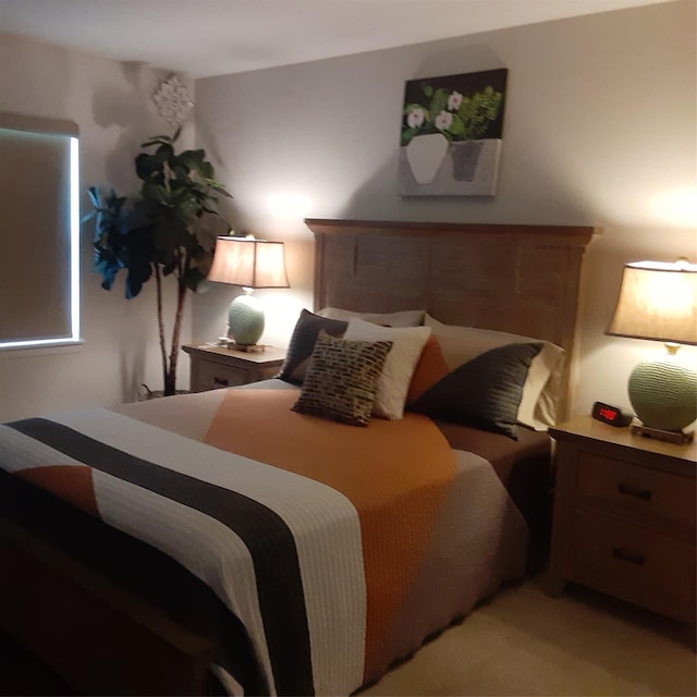 bedroom featuring light carpet