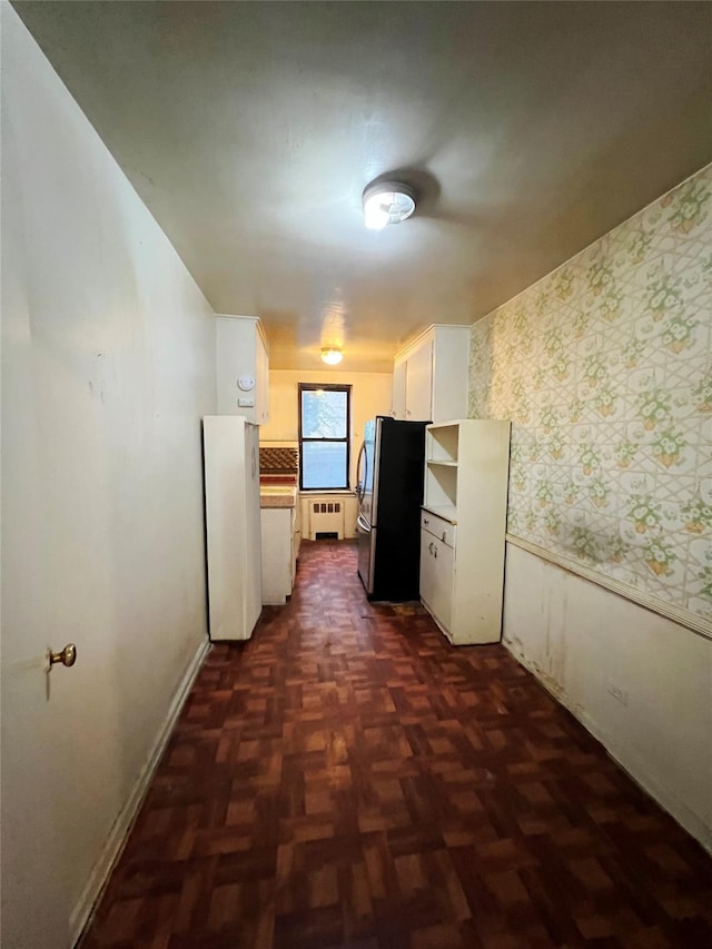 745 E 231st St Unit 1F, Bronx, NY 10466 - hallway with baseboards, radiator, wallpapered walls, and a wainscoted wall