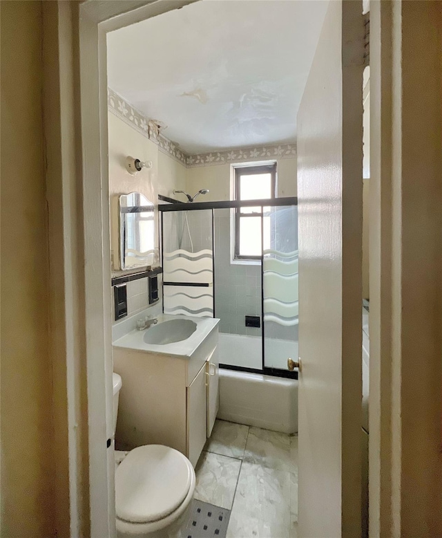 745 E 231st St Unit 1F, Bronx, NY 10466 - full bathroom featuring vanity, toilet, and bath / shower combo with glass door