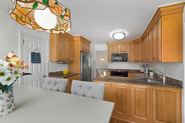 1 Red Fox Ln, Brewster, NY 10509 - kitchen with black appliances, a sink, a peninsula, dark stone counters, and wood finished floors