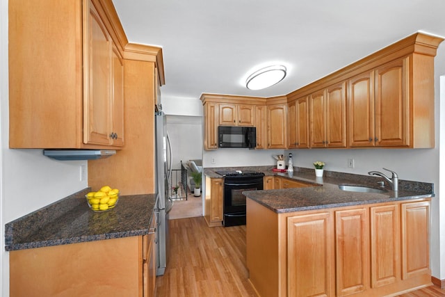 1 Red Fox Ln, Brewster, NY 10509 - kitchen featuring black appliances, a sink, light wood-style floors, a peninsula, and dark stone countertops