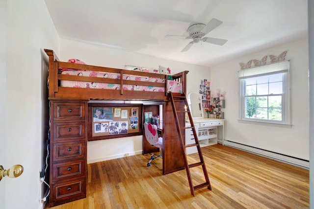 1 Red Fox Ln, Brewster, NY 10509 - bedroom with a baseboard heating unit, light wood-style floors, a desk, and ceiling fan