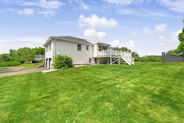 1 Red Fox Ln, Brewster, NY 10509 - rear view of house with stairs, a wooden deck, driveway, and an attached garage