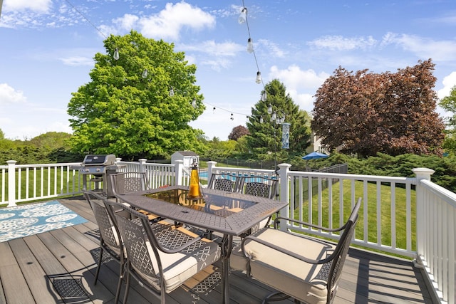 1 Red Fox Ln, Brewster, NY 10509 - deck with outdoor dining area, a lawn, a storage shed, and an outbuilding