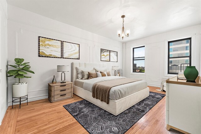 3400 Wayne Ave Unit C51, Bronx, NY 10467 - bedroom with a chandelier, light wood finished floors, radiator heating unit, and baseboards