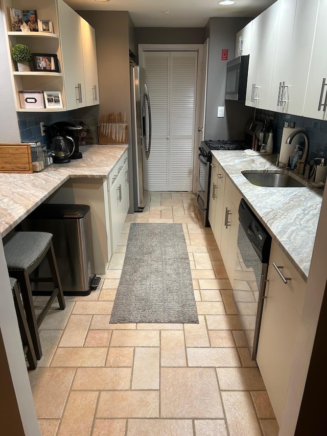 118 Skyline Dr, Coram, NY 11727 - kitchen featuring stainless steel appliances, a sink, backsplash, and white cabinets