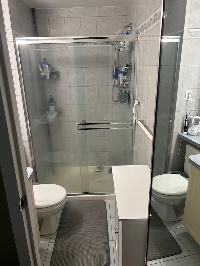 118 Skyline Dr, Coram, NY 11727 - full bathroom with toilet, tile patterned floors, vanity, tile walls, and a shower stall